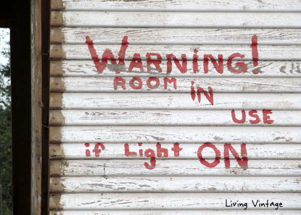 warning sign discovered on back of house under tin